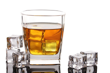 Glass of scotch whiskey and ice isolated on white