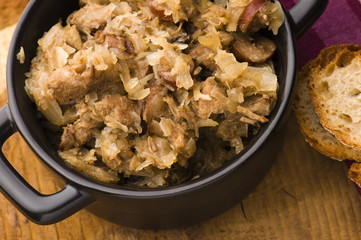 traditional polish sauerkraut (bigos) with mushrooms and plums