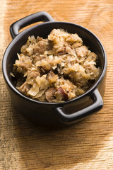 traditional polish sauerkraut (bigos) with mushrooms and plums