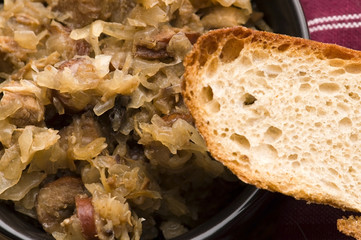 traditional polish sauerkraut (bigos) with mushrooms and plums