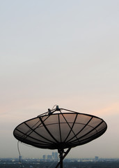 Satellite dish in sunset sky