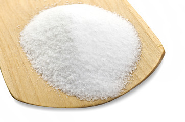 Fine salt on the spoon of wood