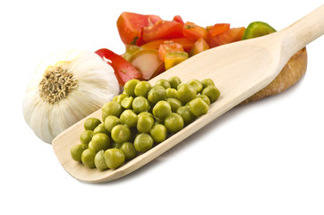 Closeup on spoon of fresh green peas