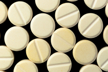 Medical pills on black background
