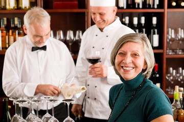 Obraz na płótnie Canvas Restaurant manager with staff at wine bar