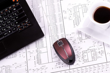 Laptop, mouse and cup of coffee on detail drawing