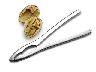 nutcracker with closed and cracked walnuts on white background