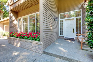 Entrance front door of the brown house.