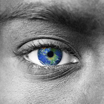 Planet earth in blue human eye