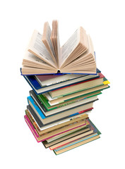open book on a pile of books on white background