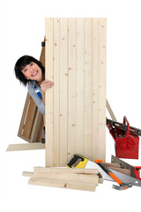 Female carpenter making a wooden door