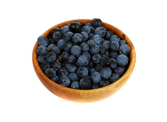 sloe, blackthorn in a wooden mortar (Prunus spinosa)