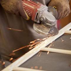 grinding the head of screws making sparks