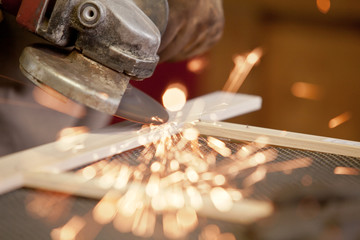 grinding the head of screws making sparks