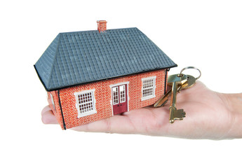 House and keys in a hand