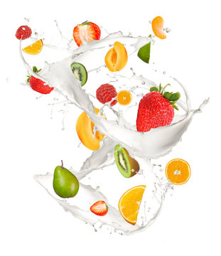 Mixed fruit in milk splash, isolated on white background