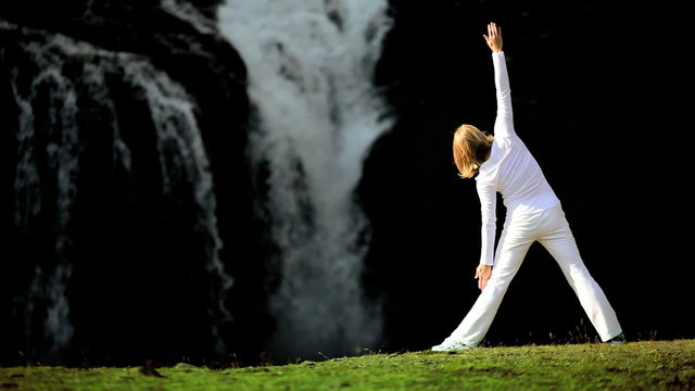 Girl Practising Yoga by Waterfall