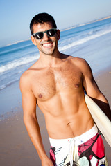 Muscular surfer with surf board