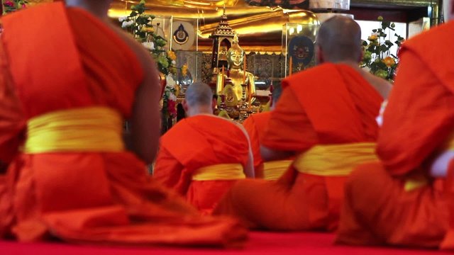 buddhist monks pray in temple