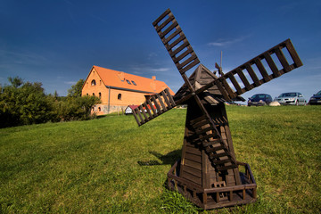 windmill and green fields - obrazy, fototapety, plakaty
