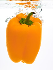 yellow pepper falling into wather