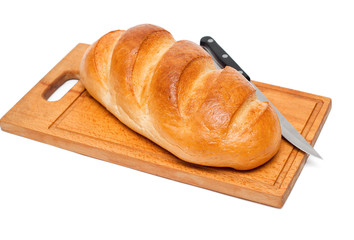 fresh bread with knife on breadboard
