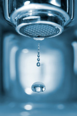 Water drop from a faucet - obrazy, fototapety, plakaty