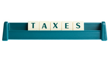 Taxes word on isolated letters board