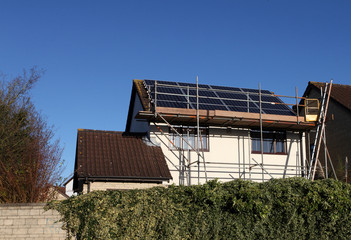 Solar panels being installed on a generic house in England