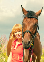 Obraz premium young pretty girl with her horse