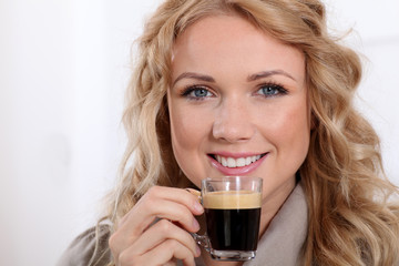 Portrait of blond woman drinking expresso