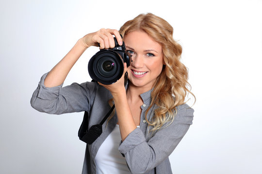 Woman using photo camera in studio