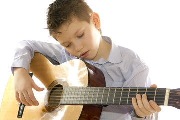 boy with an acoustic guitar isolated on white