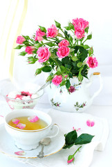 Rose bouquet and cup of tea