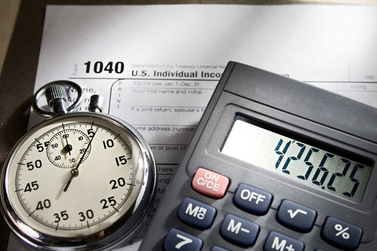 Tax form, stopwatch and calculator