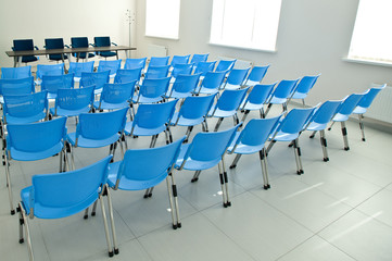 accent of arranged empty blue chairs