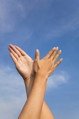 bird hand gesture in the blue sky