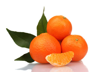 Ripe tasty tangerines with leaves and segments isolated on white