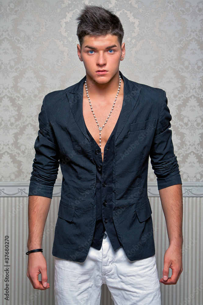 Wall mural young man posing in studio dressed in a business suit