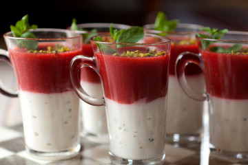 Delicious  dessert with red berries, yogurt and peppermint leaf