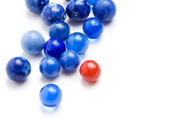 Red marble standing out in a crowd of blue marbles
