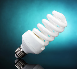 Energy saving lamp on blue background