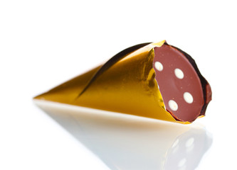 Сhocolate candy in the shape of a horn in the gold