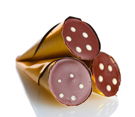 Сhocolate candy in the shape of a horn in the gold package
