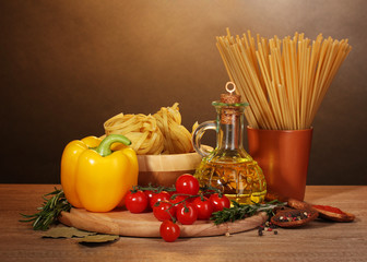 spaghetti, noodles in bowl, jar of oil and vegetables