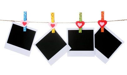 Photo paper hanging on the clothesline isolated on white