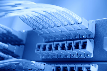 Fototapeta premium Panel of Fiber network switch with some yellow network cables