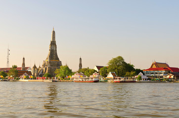Naklejka premium The stupa in the temple near the river ad thailand