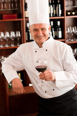 Chef cook hold wine glass in restaurant