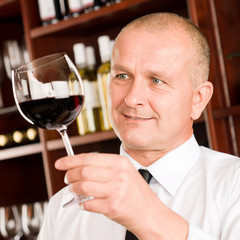 Wine bar waiter looking at glass restaurant